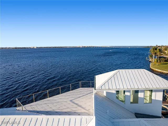 a view of roof deck with wooden floor and seating space