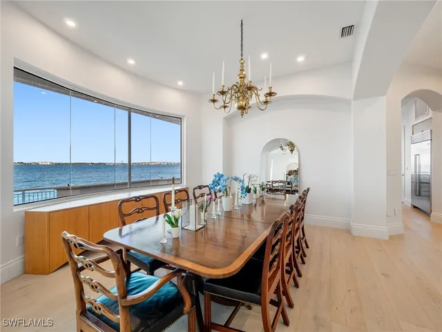 a dining room with furniture and chandelier
