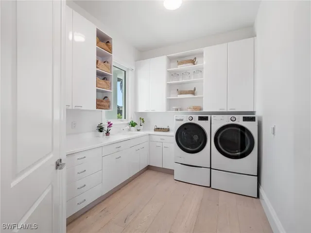 a utility room with sink dryer and washer