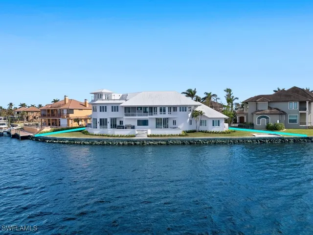 an aerial view of a house with outdoor space lake view and trees