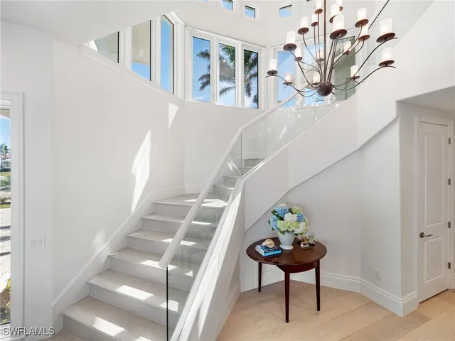 a view of staircase with furniture and a potted plant