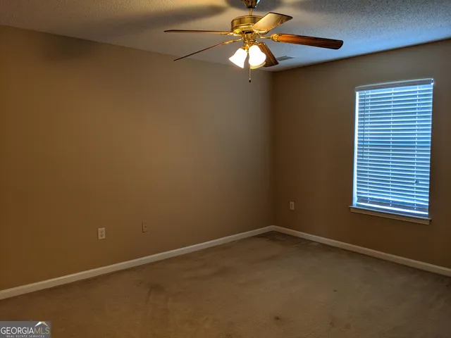 a bathroom with a granite countertop sink toilet and a mirror
