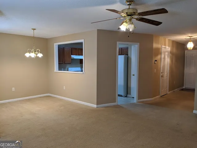 a view of an empty room with a fan