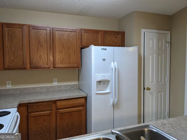 a white refrigerator freezer sitting inside of a kitchen