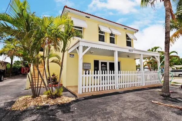 a view of a house with iron fence