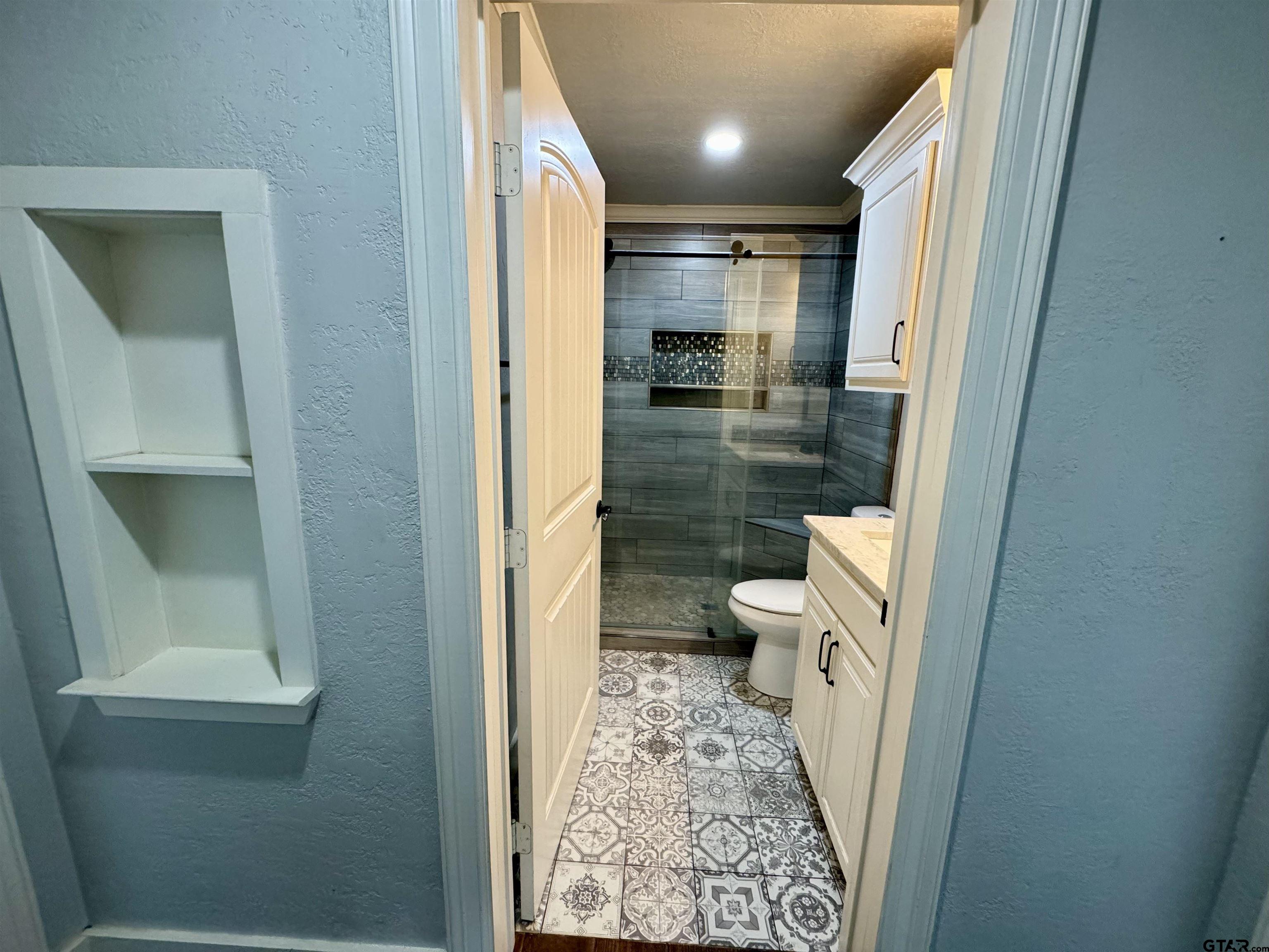 403 East Henderson Street Overton, TX 75684 - Photo 14 of 31 a bathroom with a sink and a toilet