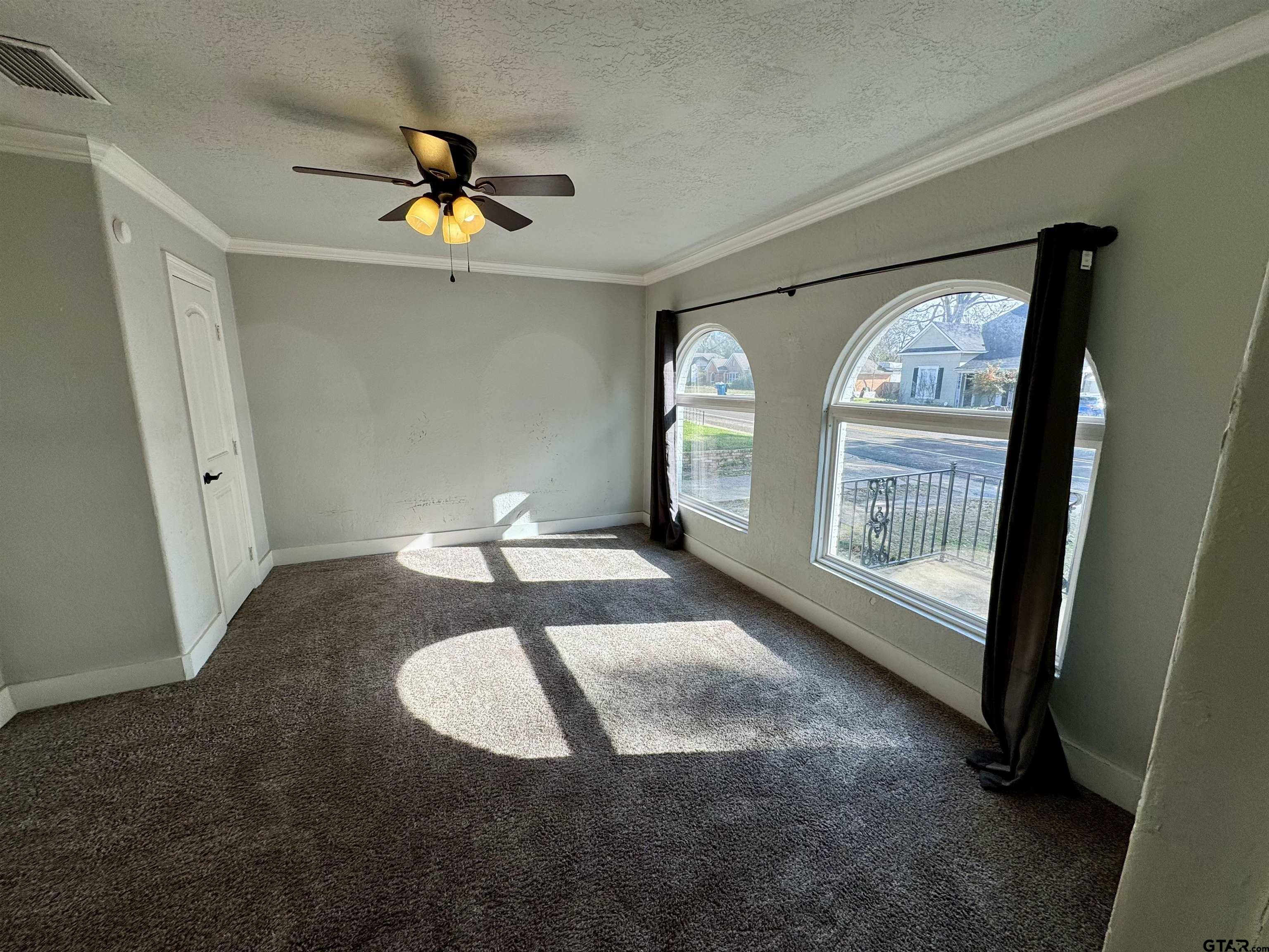 403 East Henderson Street Overton, TX 75684 - Photo 17 of 31 en empty room with windows and outdoor view