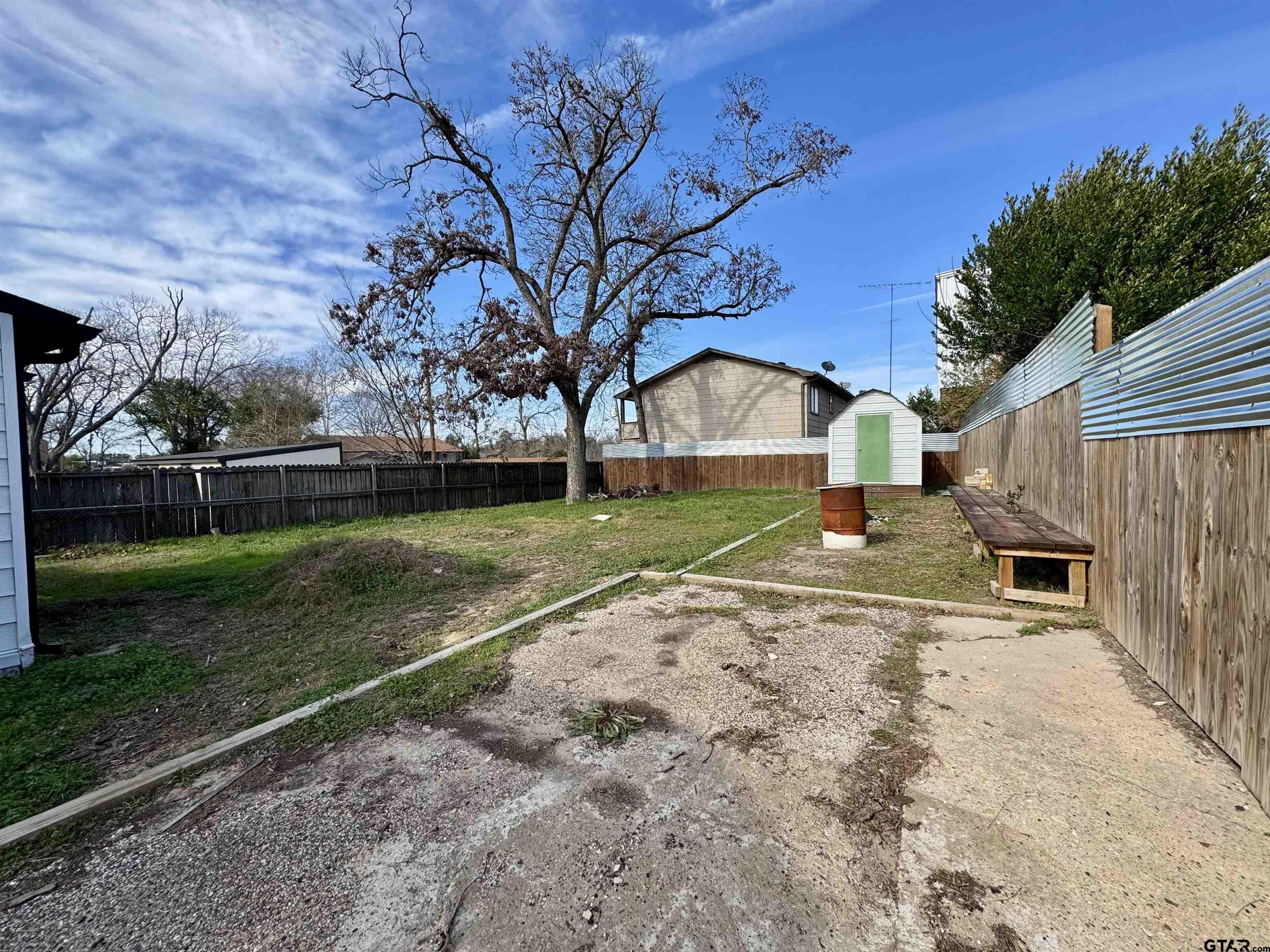 403 East Henderson Street Overton, TX 75684 - Photo 21 of 31 a view of a house with backyard and tree