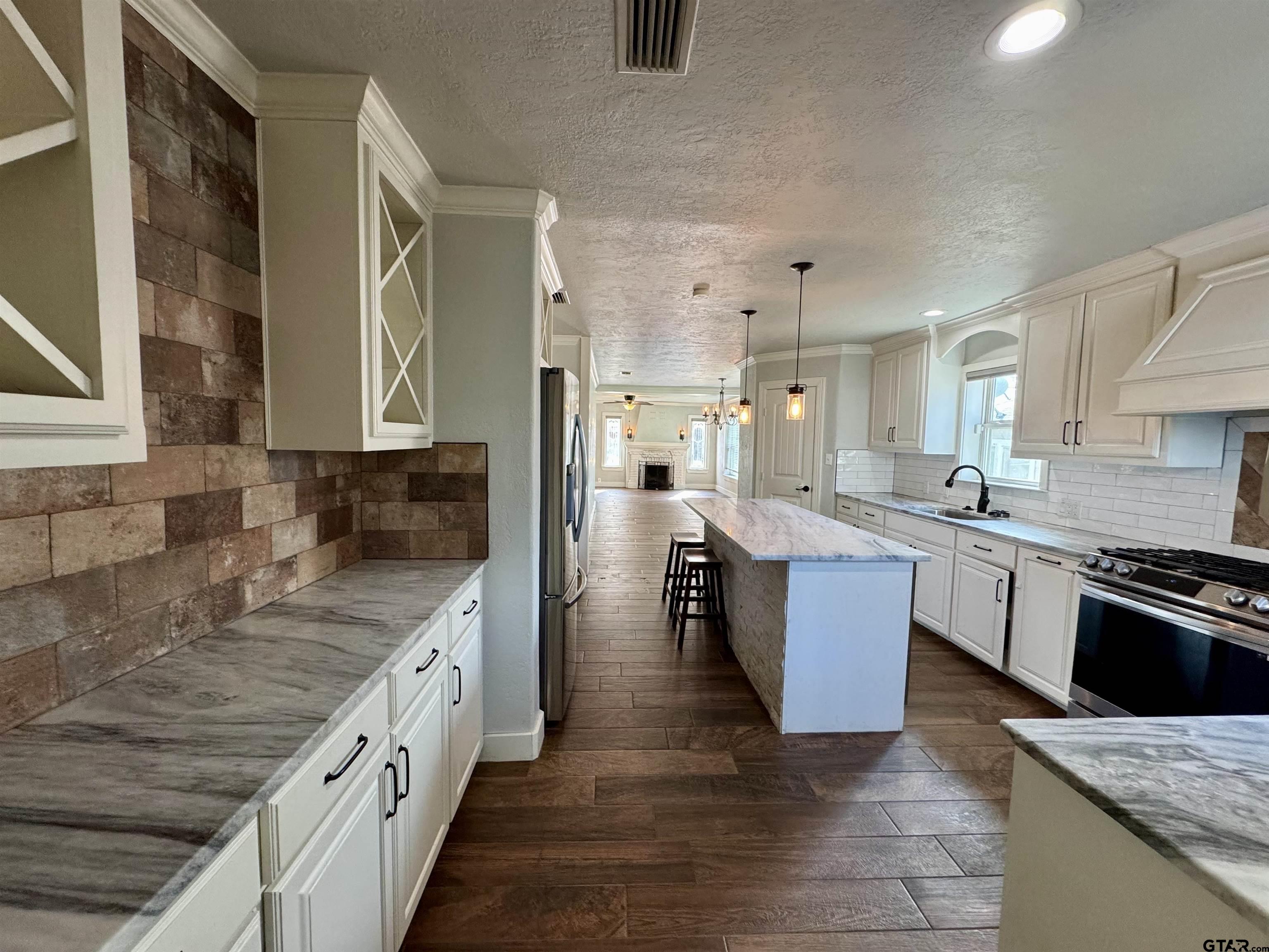 403 East Henderson Street Overton, TX 75684 - Photo 5 of 31 a large kitchen with stainless steel appliances granite countertop a lot of counter space and a sink