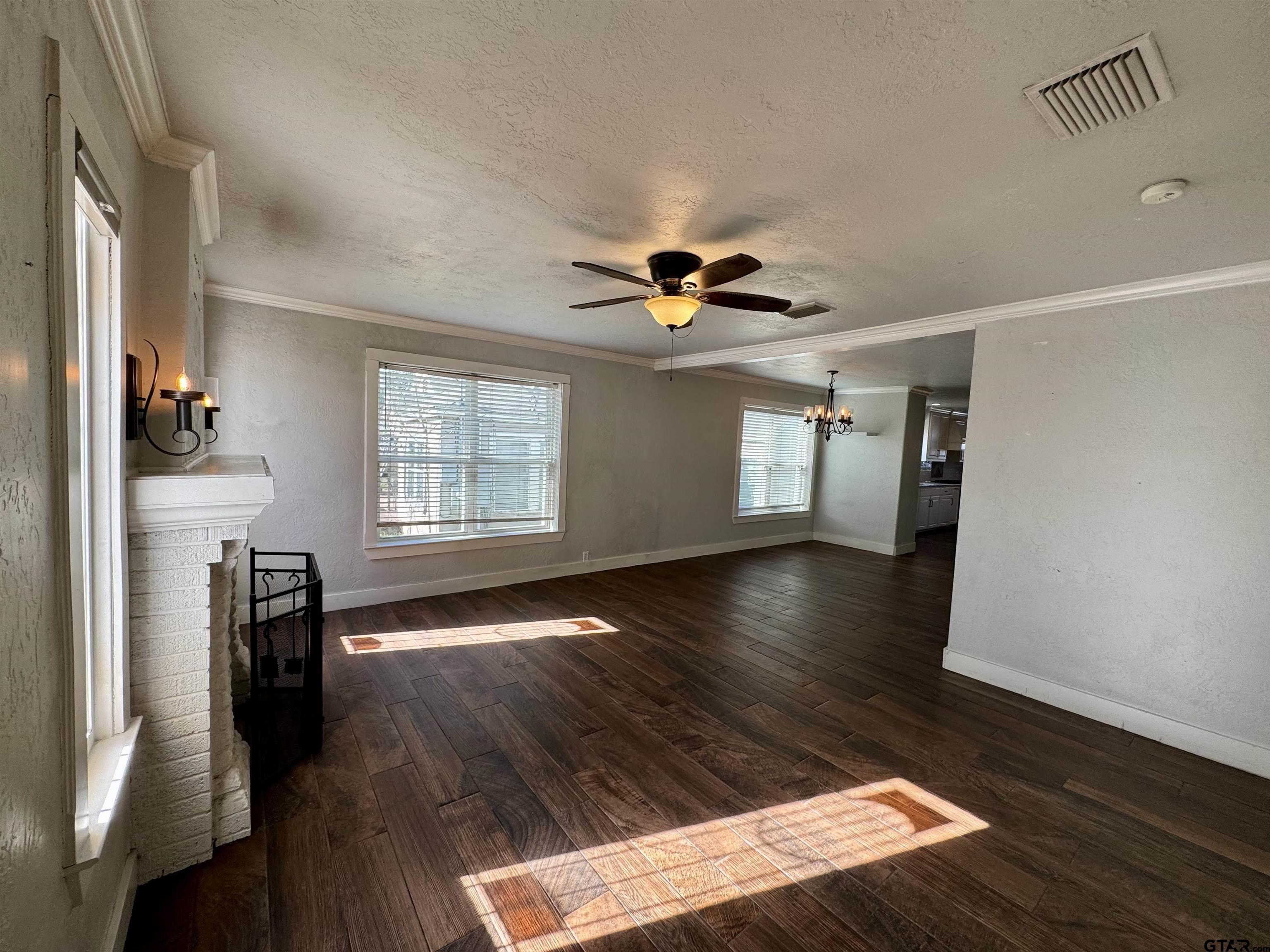 403 East Henderson Street Overton, TX 75684 - Photo 7 of 31 a view of an empty room with wooden floor and a window