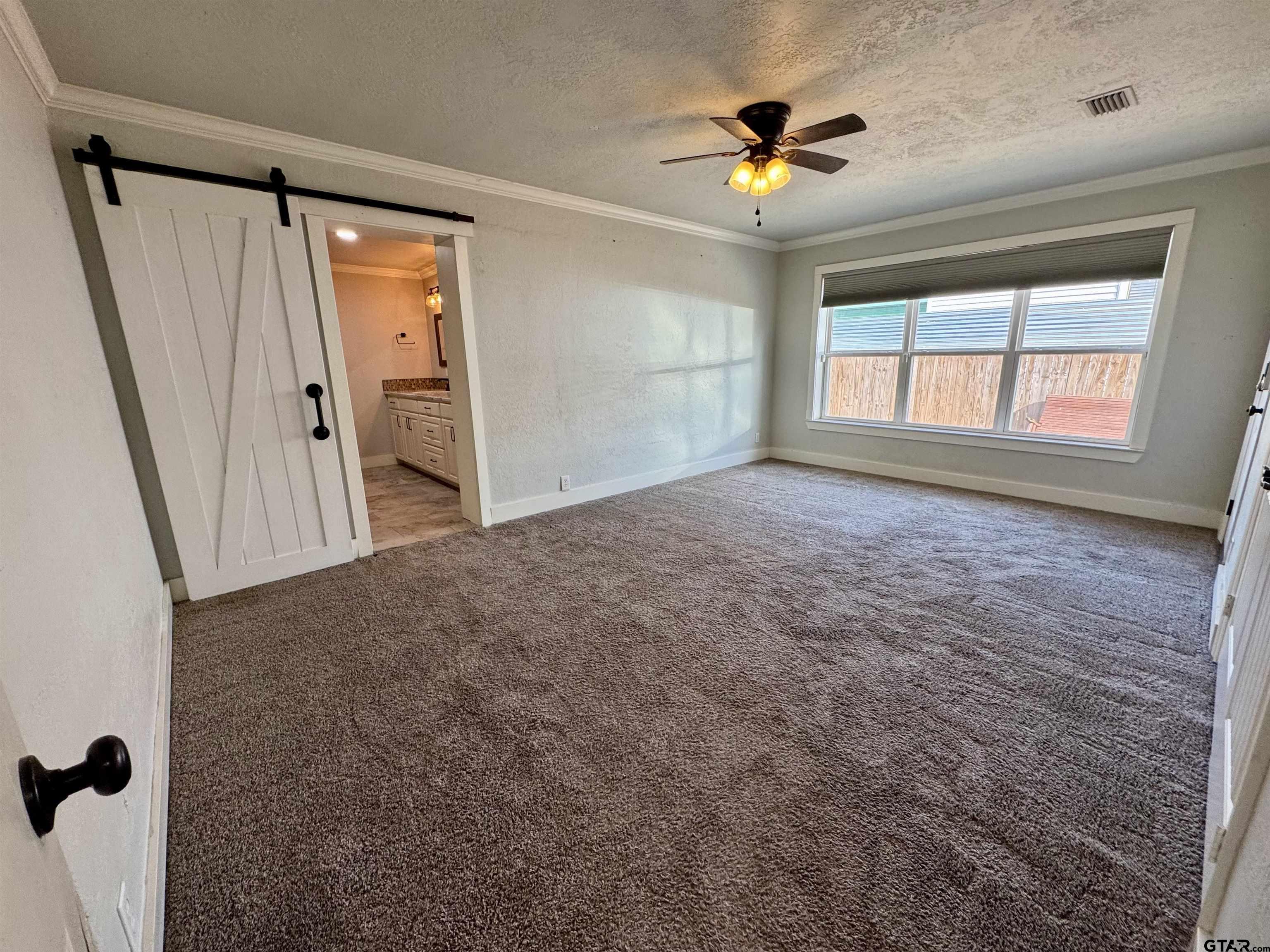 403 East Henderson Street Overton, TX 75684 - Photo 8 of 31 wooden floor in an empty room with a window