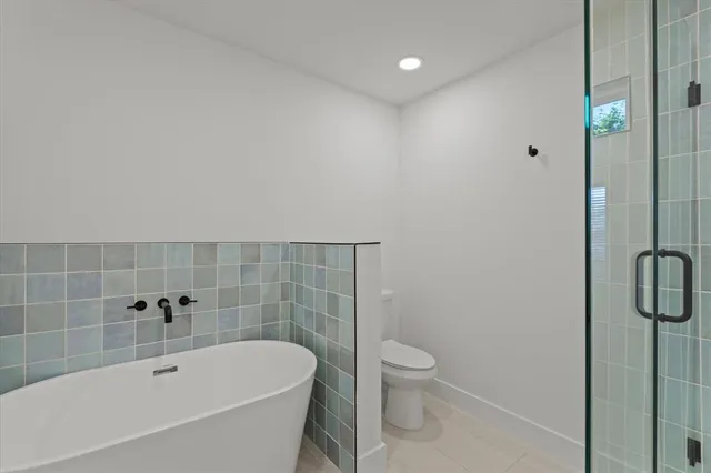 a white bath tub sitting next to a white toilet