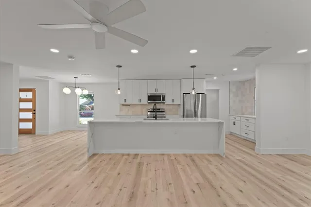 a view of kitchen with sink microwave and refrigerator