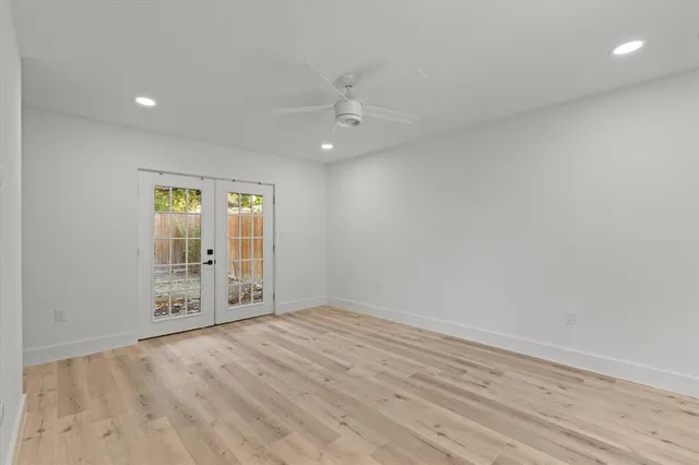 an empty room with windows and cabinet