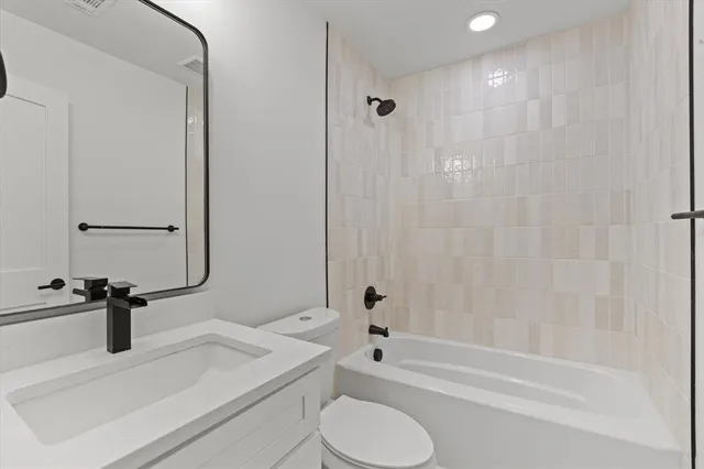 a bathroom with a sink a toilet and a bathtub