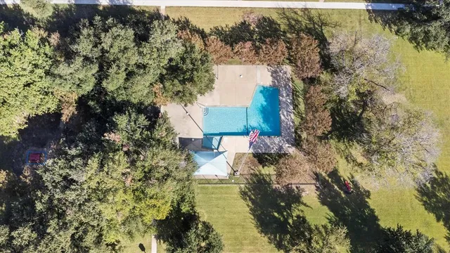 a aerial view of a house with a yard and lake view