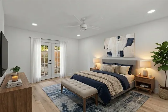 a bedroom with a bed and wooden floor