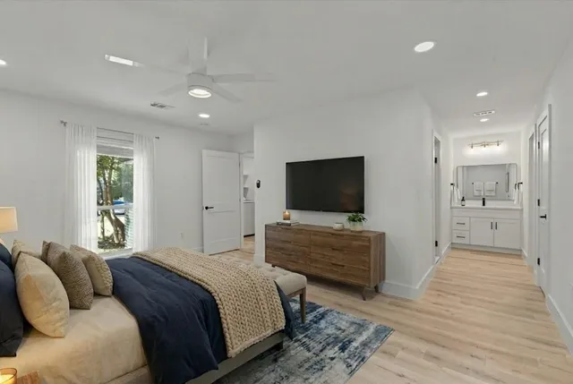 a bedroom with a bed and a flat screen television