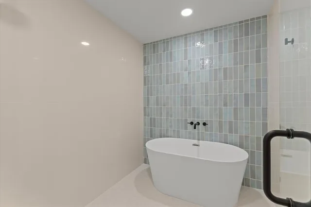 a white bath tub sitting in a bathroom
