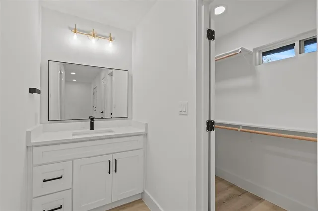 a bathroom with a double vanity sink mirror and