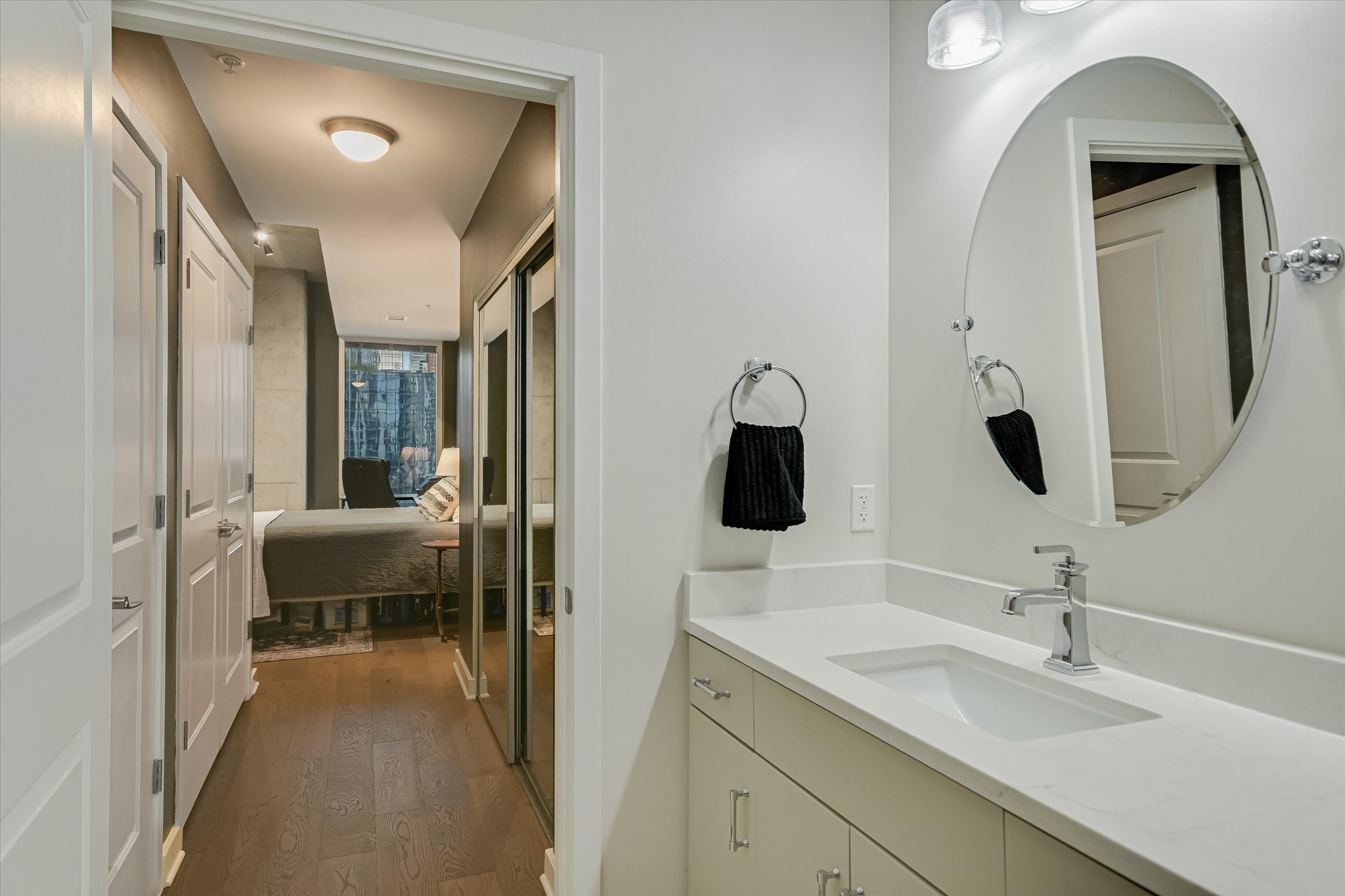 360 Nueces Street, Unit 1405 Austin, TX 78701 - Photo 23 of 40 a en suite bathroom with a toilet sink and mirror