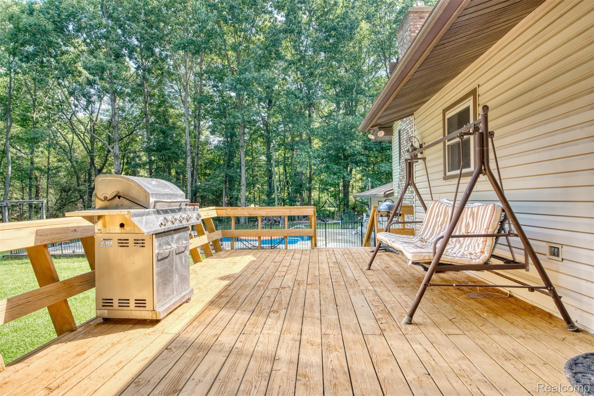 11813 Newman Road Brighton, MI 48114 - Photo 25 of 33 Enjoy pool and wooded views