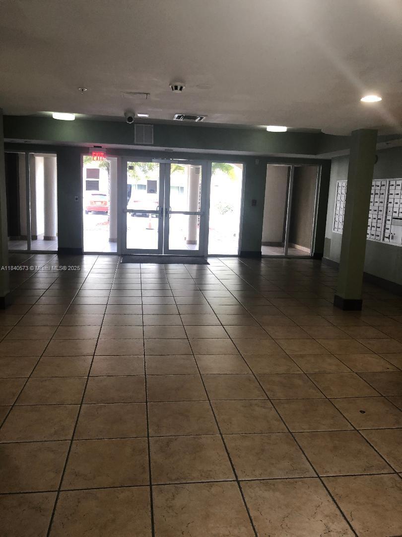 11060 Southwest 196th Street, Unit 601 Cutler Bay, FL 33157 - Photo 9 of 9 a view of an empty room with window and chandelier fan