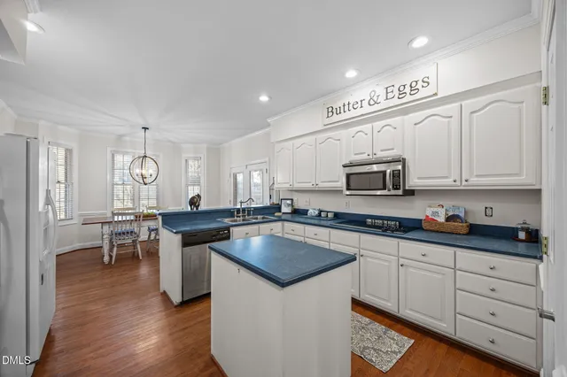 a kitchen with stainless steel appliances granite countertop a sink stove and cabinets