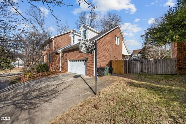 a view of a house with wooden fence