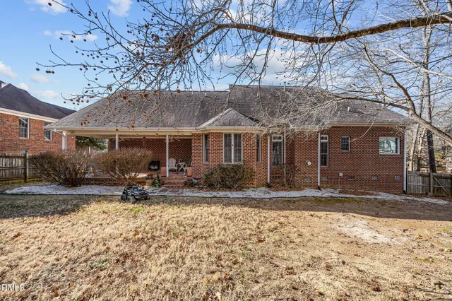 a view of a house with a yard covered in snow