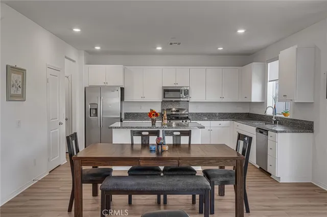 a view of a dining room with furniture and wooden floor