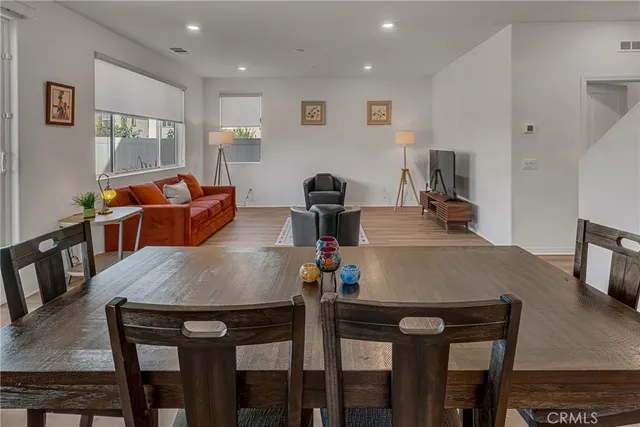 a kitchen with granite countertop white cabinets stainless steel appliances and a counter space