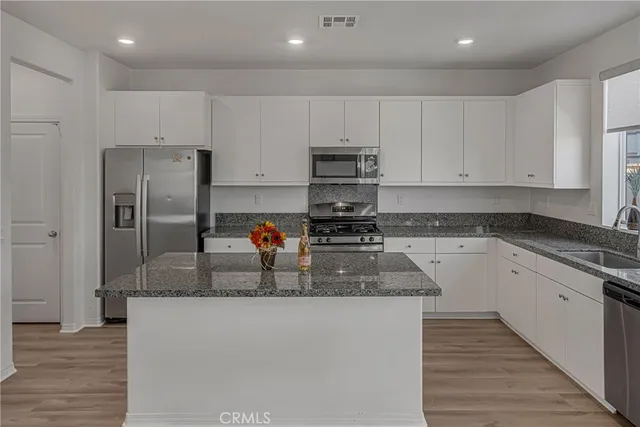 a stove top oven sitting inside of a kitchen