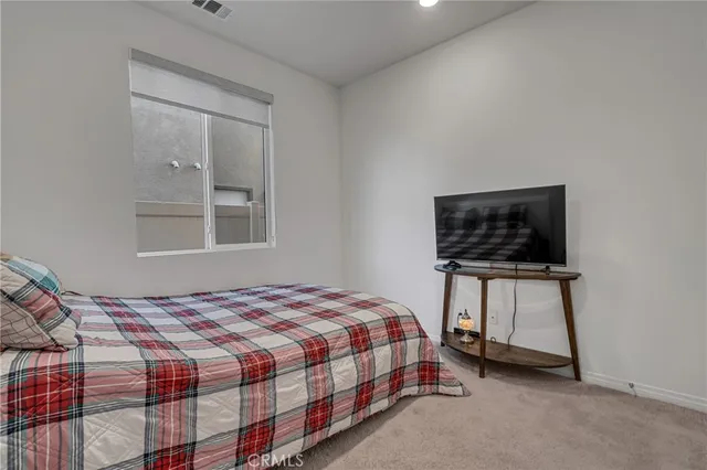 a bedroom with a bed and a chair