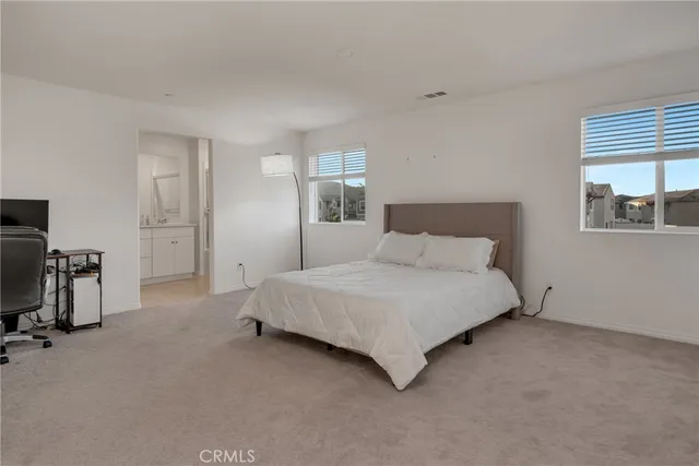 a bedroom with a bed and a lamp