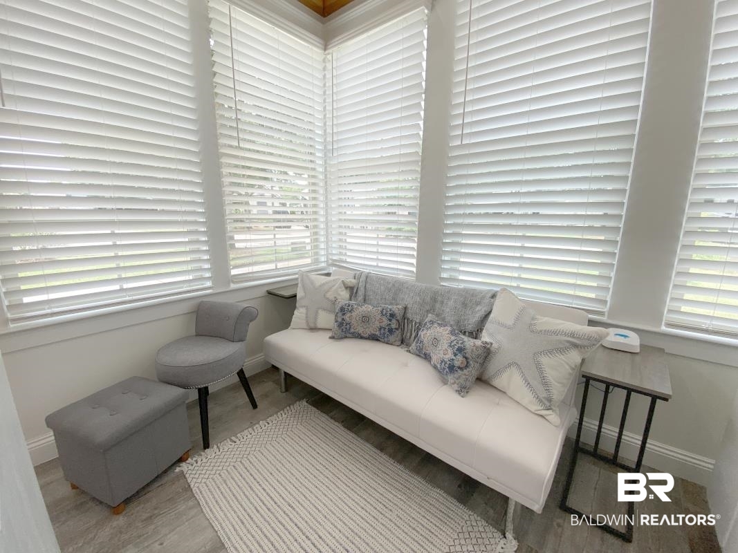 28888 Canal Road, Unit 77 Orange Beach, AL 36561 - Photo 2 of 23 Sunroom with extensive window coverage and white horizontal blinds