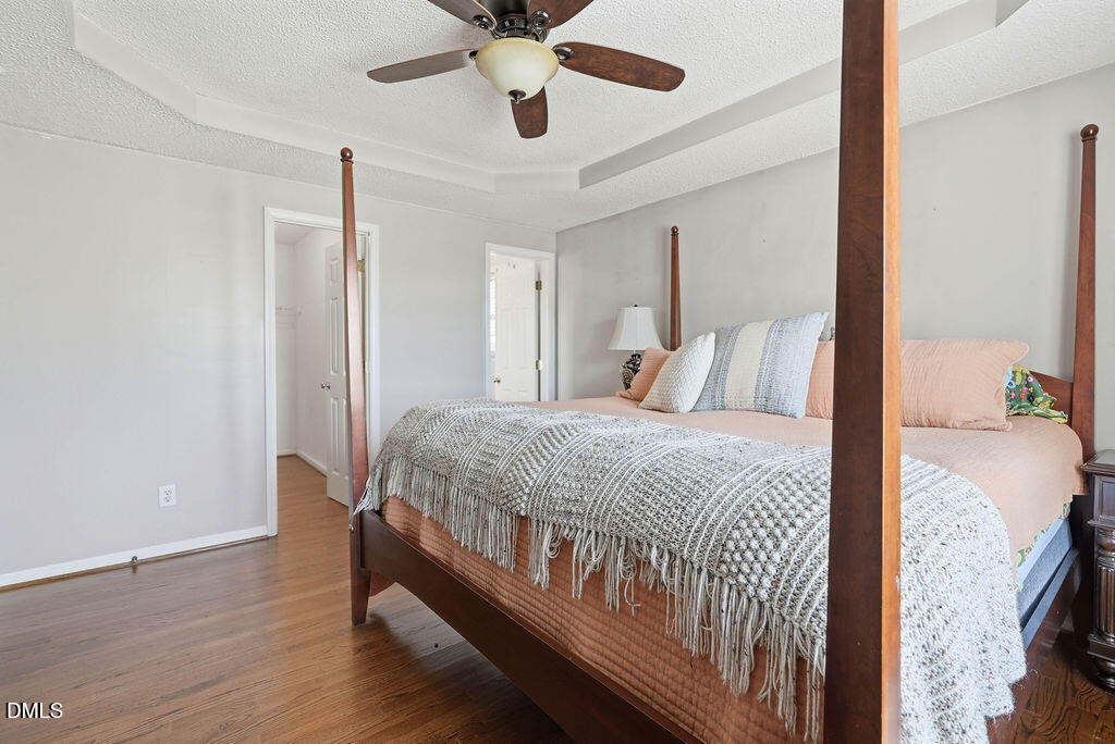1560 Cane Mill Road Coats, NC 27521 - Photo 22 of 32 a bedroom with a bed and a chandelier