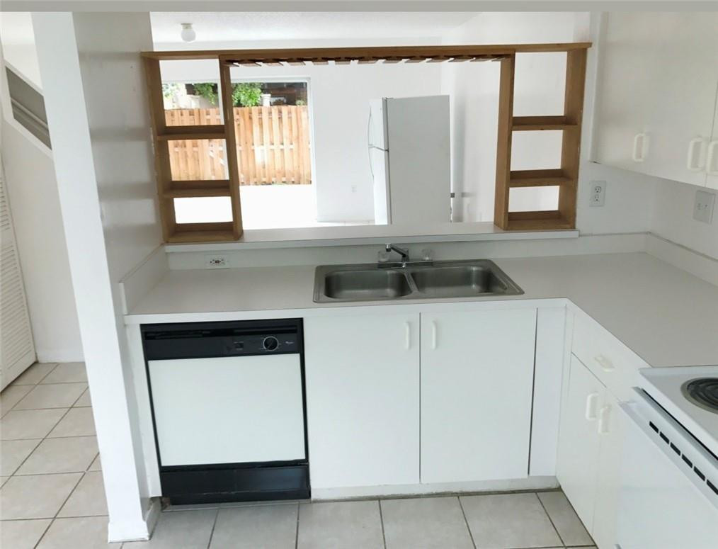 14085 Southwest 179th Terrace Miami, FL 33177 - Photo 2 of 6 a kitchen with white cabinets and a sink