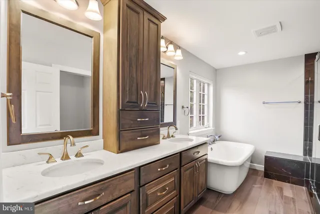 a spacious bathroom with a double vanity sink mirror and toilet