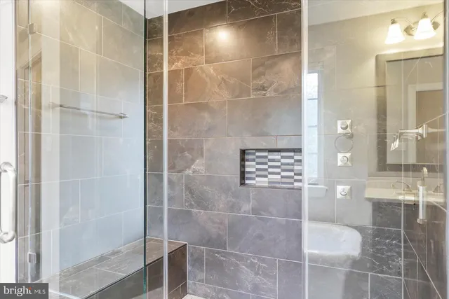a bathroom with a glass shower door