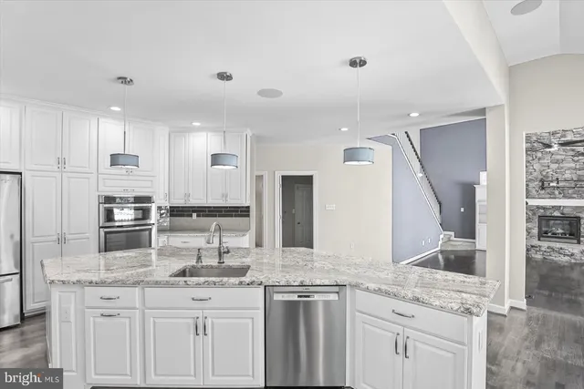 a kitchen with counter top space cabinets and stainless steel appliances