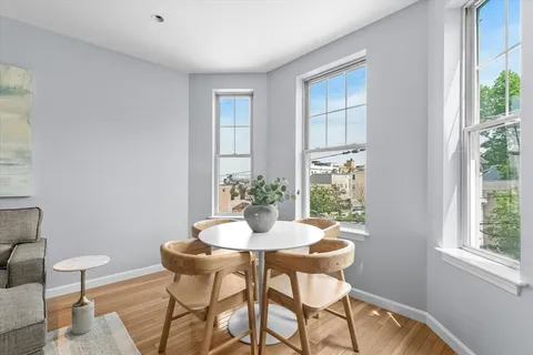 a dining room with furniture and window