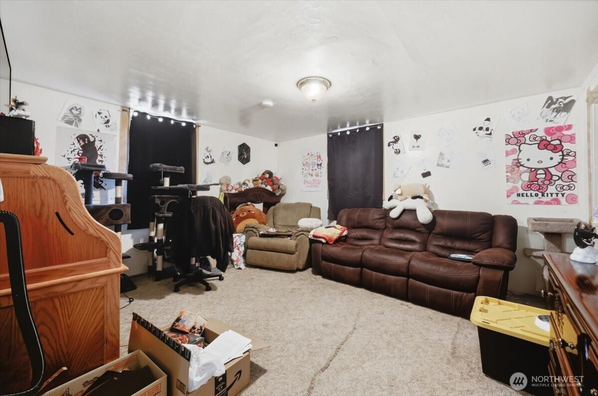 802 South 11th Avenue Pasco, WA 99301 - Photo 15 of 24 a living room with furniture a flat screen tv and a refrigerator