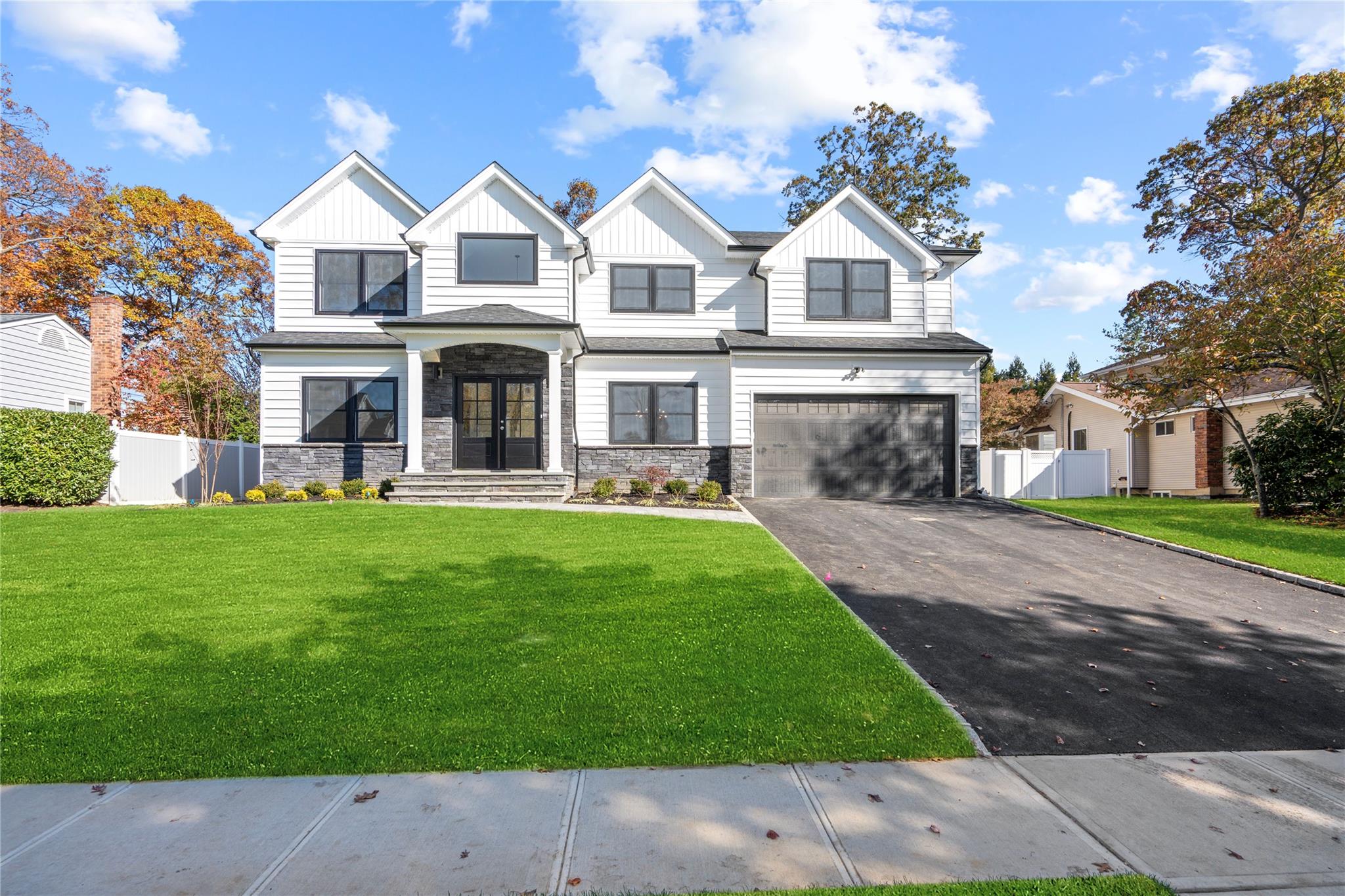 1 Newport Drive Plainview, NY 11803 - Photo 1 of 1 View of front of property with a garage, a front yard, and french doors