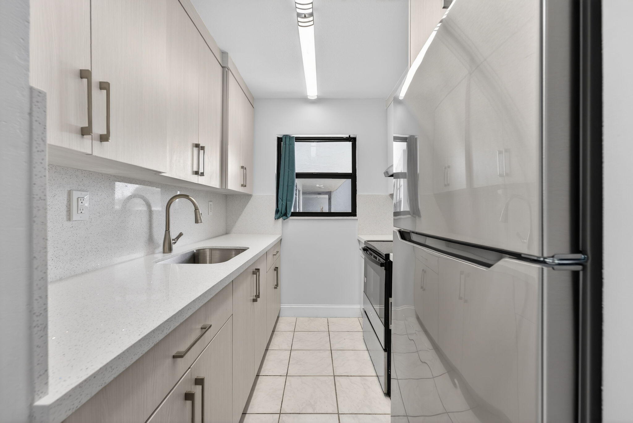 a kitchen with a refrigerator and a sink