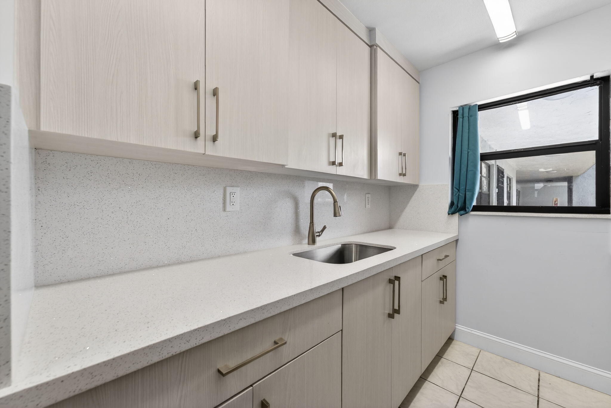 1335 West 68th Street, Unit 208 Hialeah, FL 33014 - Photo 13 of 20 a kitchen with a sink and cabinets