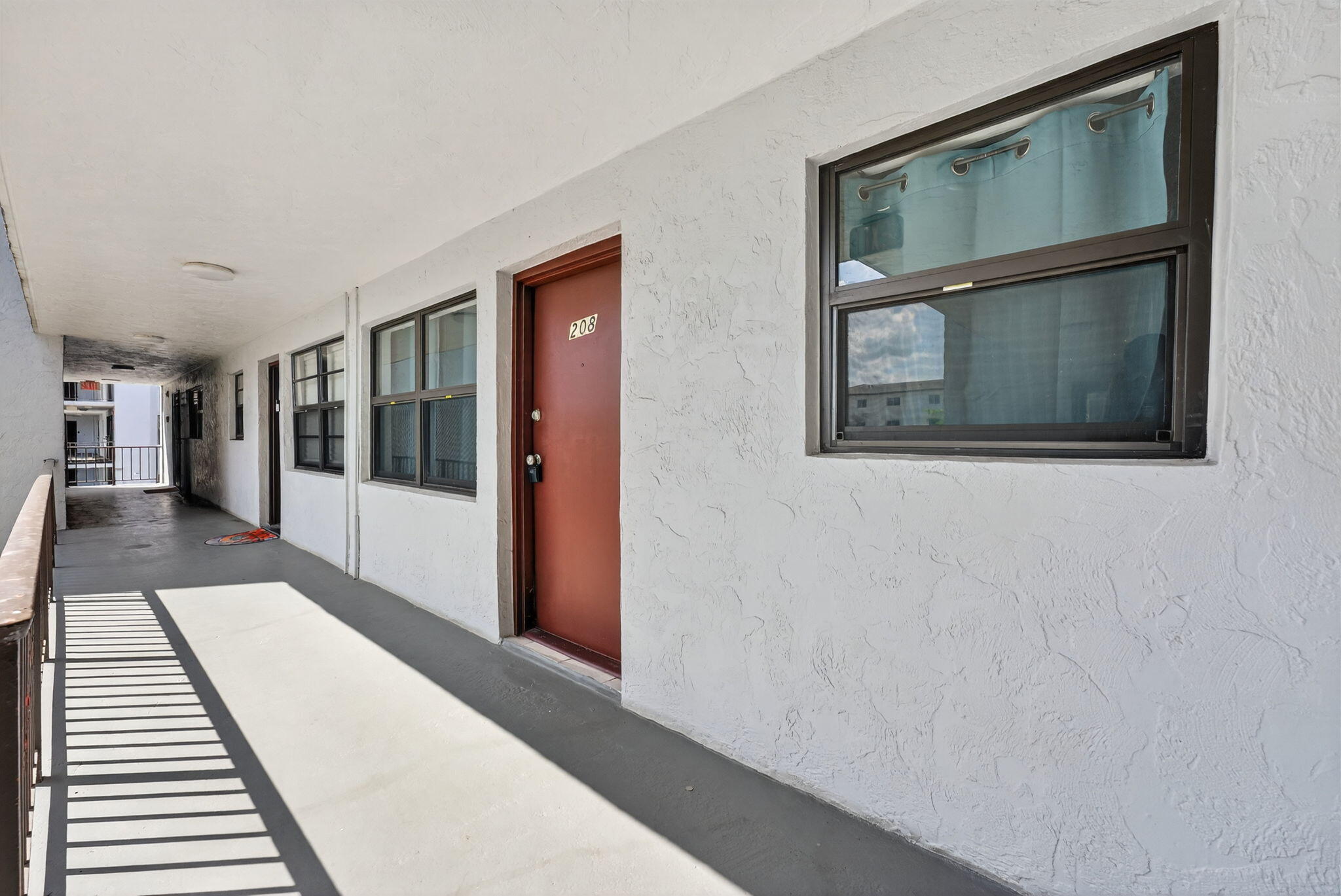 1335 West 68th Street, Unit 208 Hialeah, FL 33014 - Photo 20 of 20 a hallway with front door