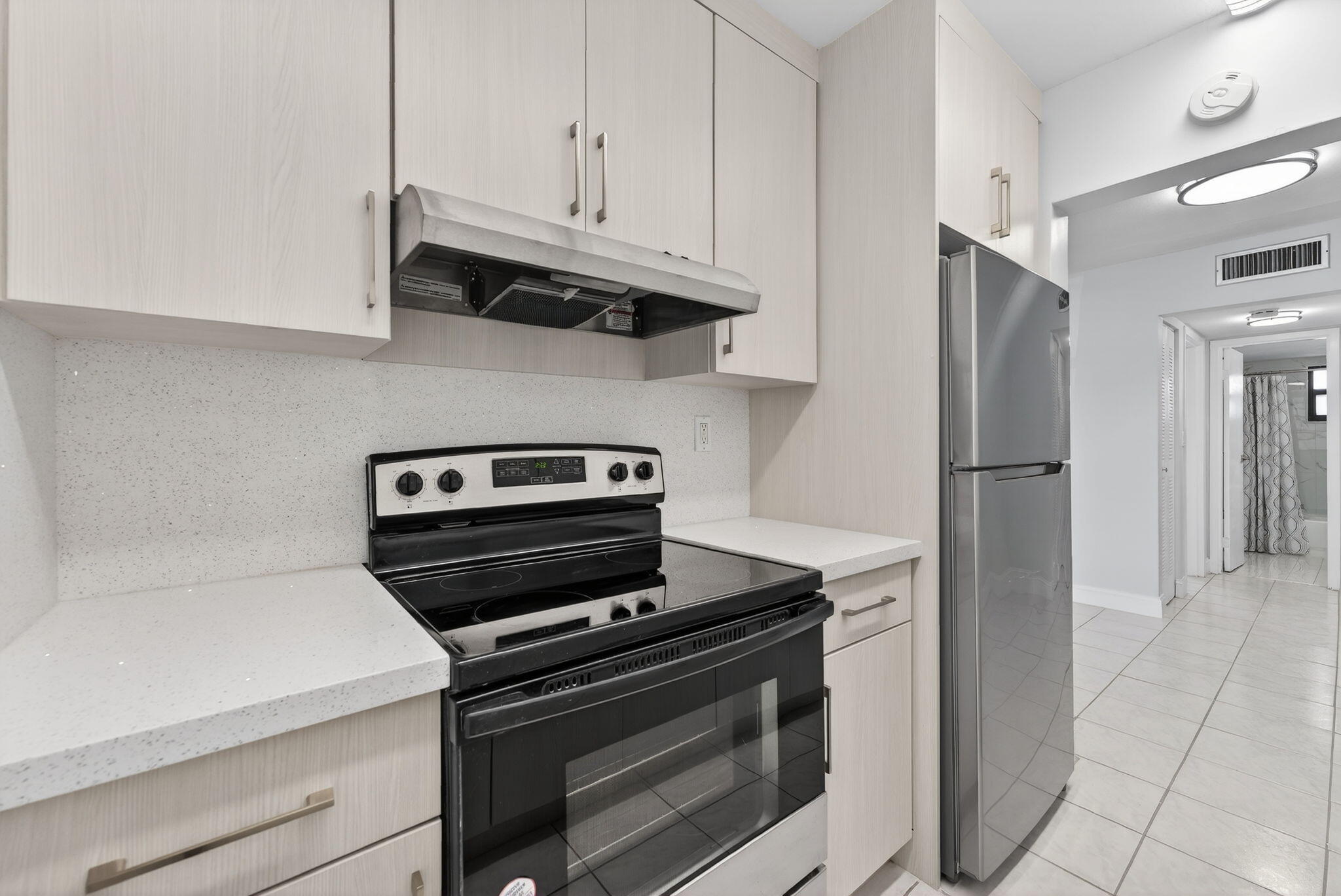 1335 West 68th Street, Unit 208 Hialeah, FL 33014 - Photo 6 of 20 a kitchen with appliances and cabinets
