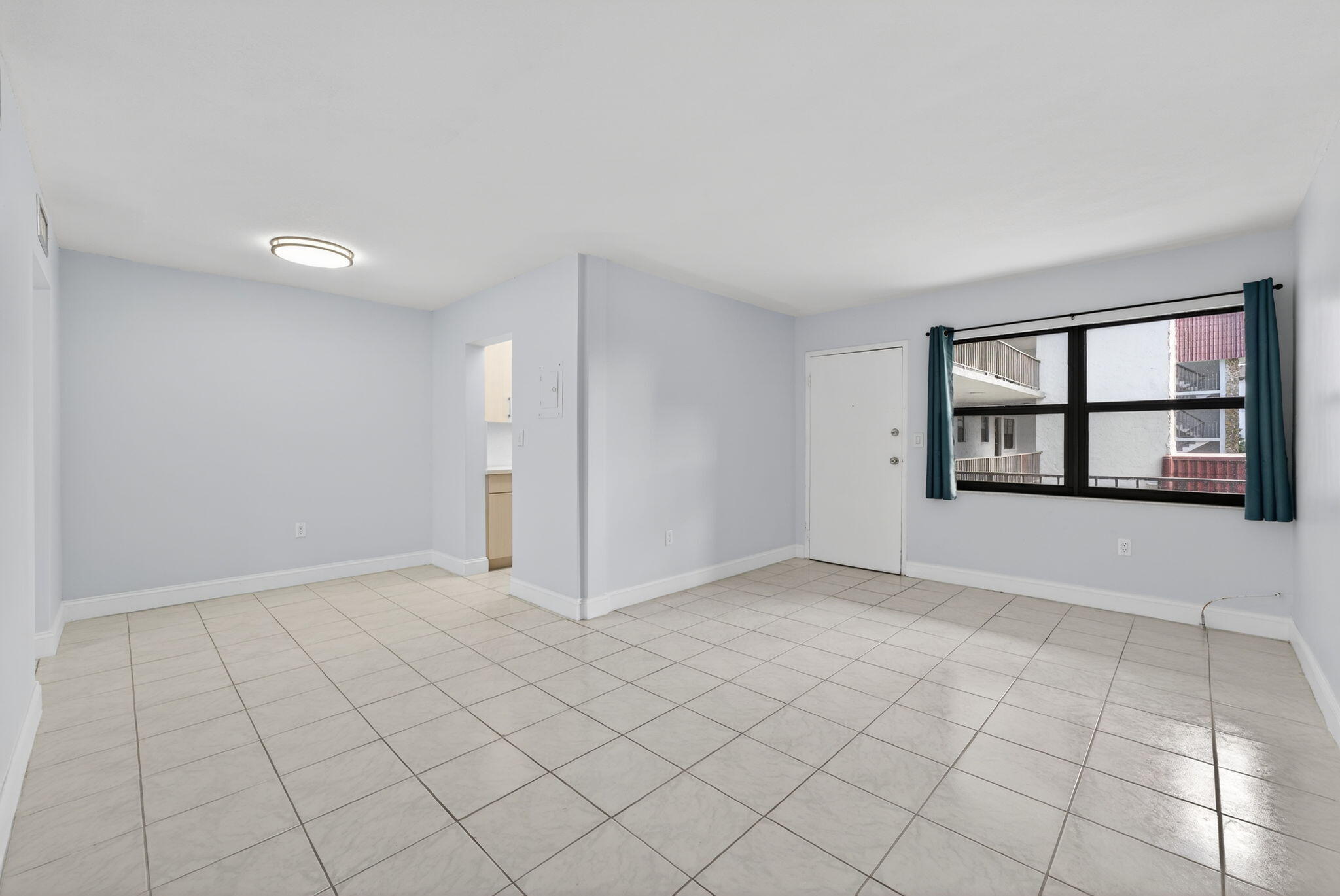 1335 West 68th Street, Unit 208 Hialeah, FL 33014 - Photo 7 of 20 a view of an empty room with a window and a fireplace