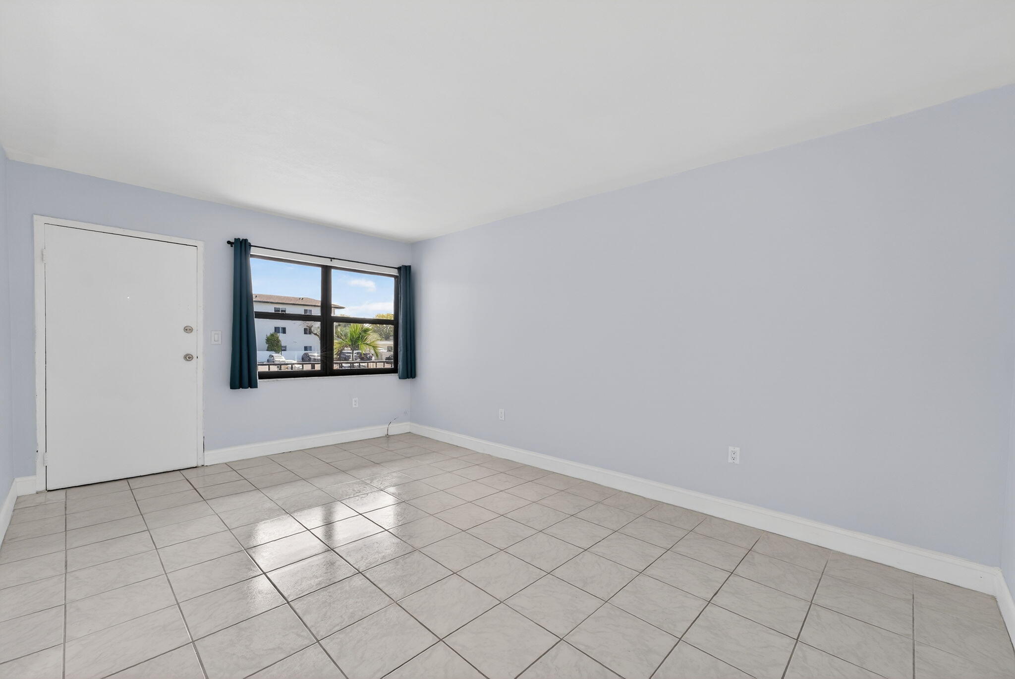 1335 West 68th Street, Unit 208 Hialeah, FL 33014 - Photo 10 of 20 an empty room with windows